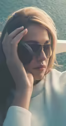 a woman sitting on a boat talking on her cell phone