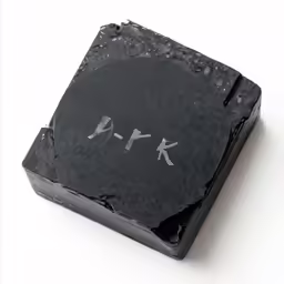 a piece of black and white stone with grey paint