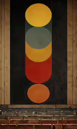 an art work with different colors on a black wall