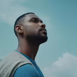 a black man looks up into the sky