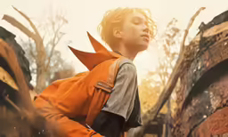 an attractive young girl with a large backpack and headgear looking away from the camera