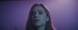 a woman is staring into the camera