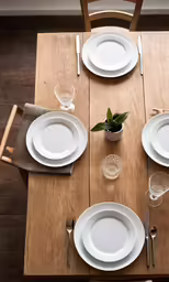 a table set with plates, silverware and other place setting