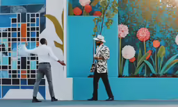 two men who are standing near a painting