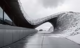 a walkway leading to a very tall building under a bridge