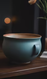 an old wooden bowl sits on a desk