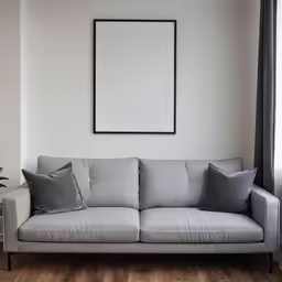 a sofa with two pillows and a coffee table with vases