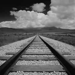 a black and white photo of two tracks running in opposite directions