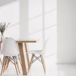 a set of three chairs near a table with flowers in the middle
