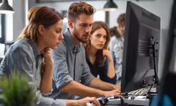 a group of people working at computers together