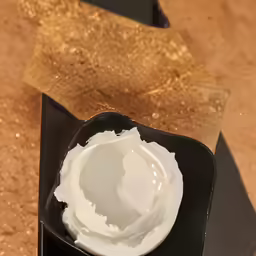 a bowl with whipped cream inside of it