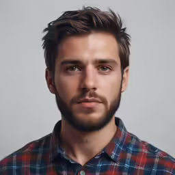 a man in checkered shirt posing for camera