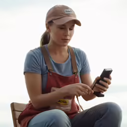 a woman sitting on a bench with an object