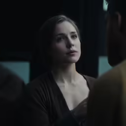 a woman talking to another man about something