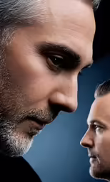 an artistic portrait of a man looking over the shoulder of another man