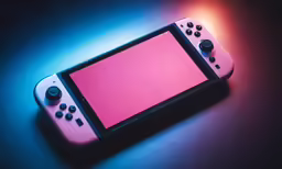 the video game controller is shown with a pink screen