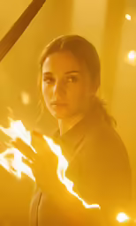 a woman that is holding a fire wand