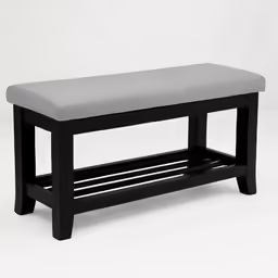 a black and white bench sitting on top of a white floor