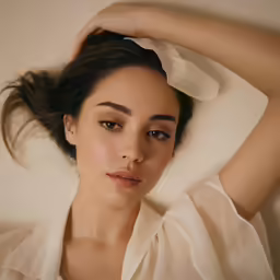 a woman with brown eyes in a blouse