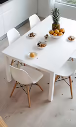 a large white table with plates of fruit on it
