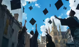 several people throwing graduation caps in the air
