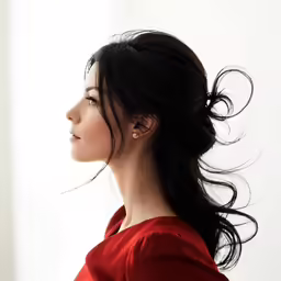 a woman with her hair in a ponytail