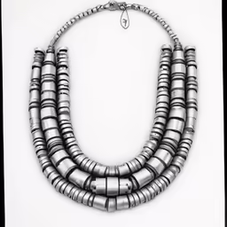 a necklace of silver colored metal discs on a silver chain