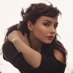 a woman with dark hair is posing for the camera