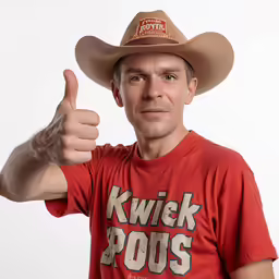 a man is wearing a cowboy hat giving a thumbs up