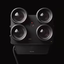 a square camera with three lenses attached to it