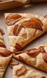 several slices of pizza are cut into four pieces