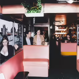 a group of people sitting down and having conversation