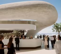 people stand in a lobby where visitors mingle
