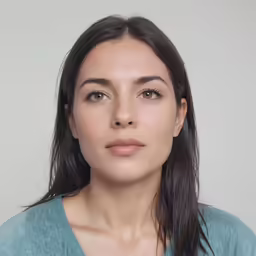a woman with an earring on looking at the camera