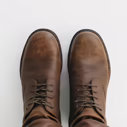 a pair of brown leather boots on a white background