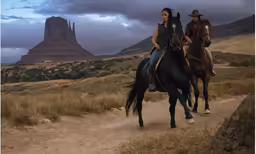a couple of men riding on the backs of brown horses