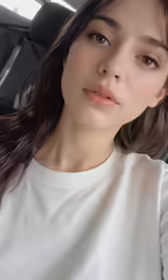 the girl wearing a white sweater and her hair in wind