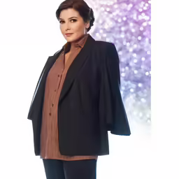 a woman standing in front of purple lights