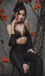 a beautiful woman sitting on a chair posing