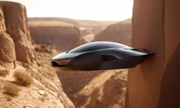an unusual futuristic airplane flying over some rocks