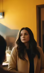 a woman in black and tan looking ahead while seated down