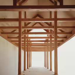 an open building with multiple wood trusses