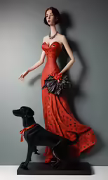 a statue of a woman in a red dress stands next to a black dog