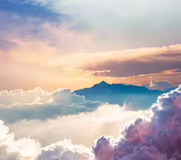 the sky is full of clouds as the sun sets,the clouds are very high and there is some clouds in the sky