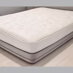 the top of a mattress sits on top of a wooden floor
