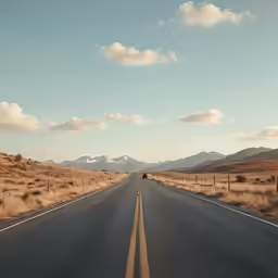 a truck is parked on the road by a mountain