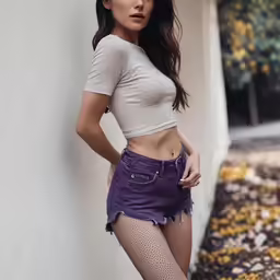 a beautiful woman in tights and short shorts poses for a magazine