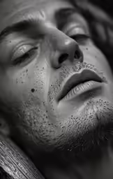 black and white photo of man laying in bed
