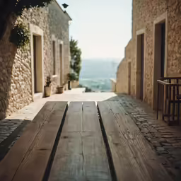 an old house in the mountains is lined with large wooden boards