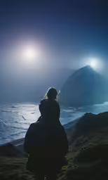 a person standing at the edge of a cliff looking out into the ocean